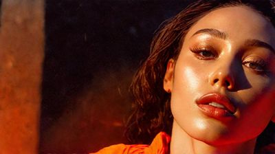 a close up of a person wearing a bright orange shirt