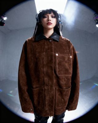 a woman wearing headphones standing in front of a mirror