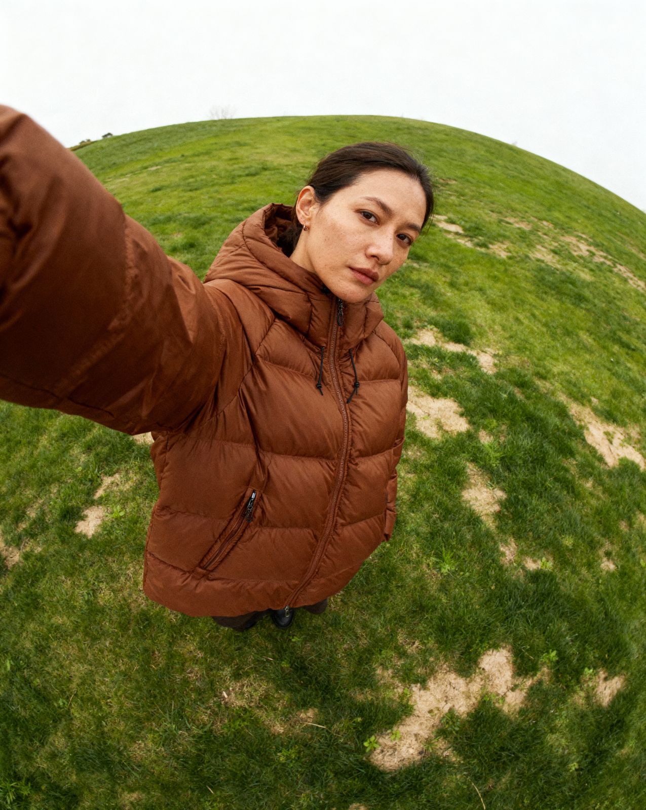 a woman standing on top of a lush green field