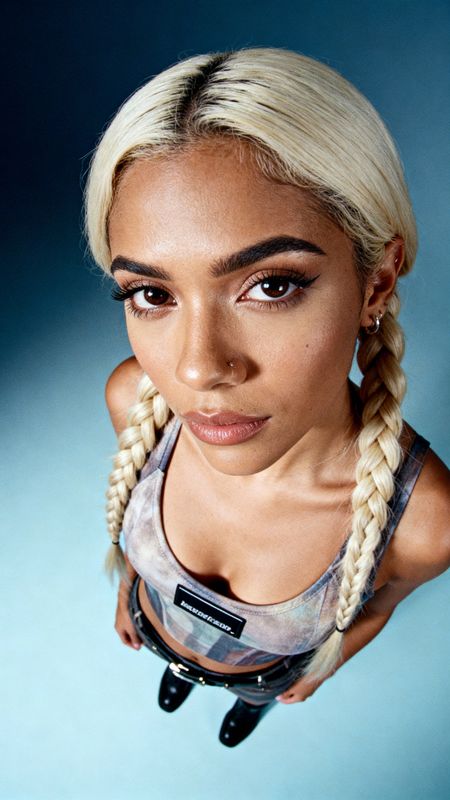 a woman with blonde hair and a pair of scissors