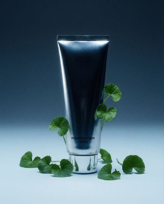 a tube of toothpaste with a plant growing out of it