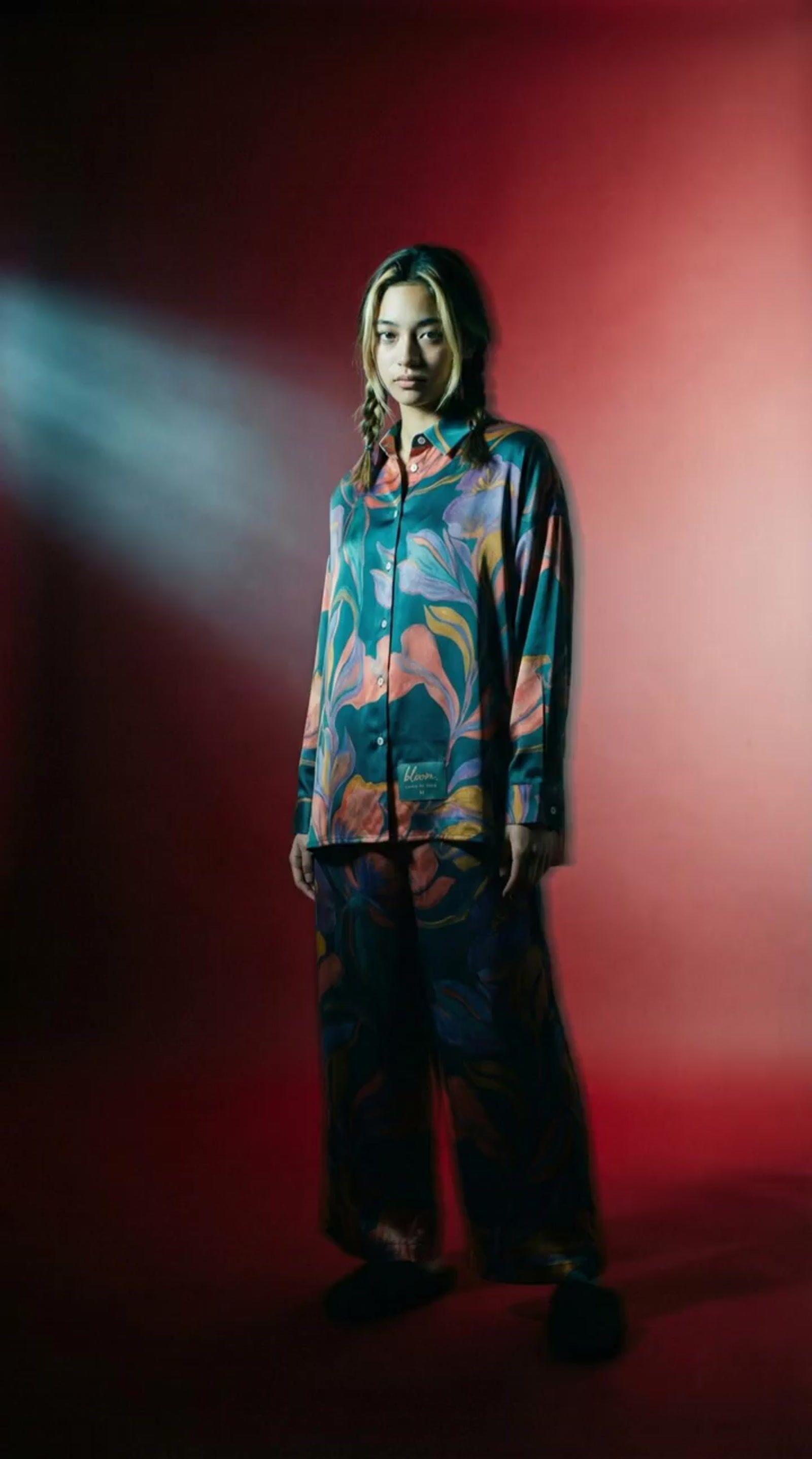 a woman standing in front of a red wall