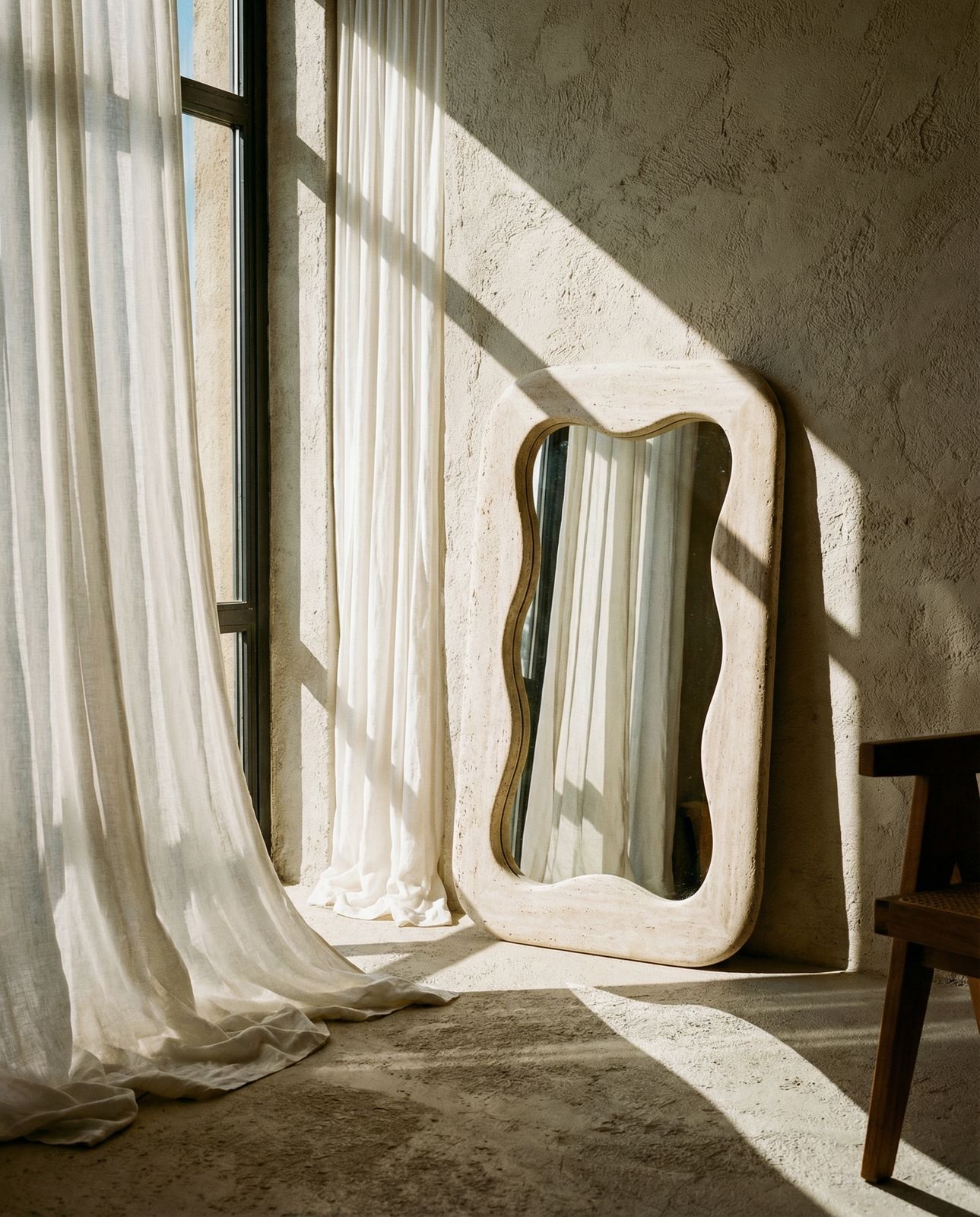 a mirror sitting on top of a table next to a window