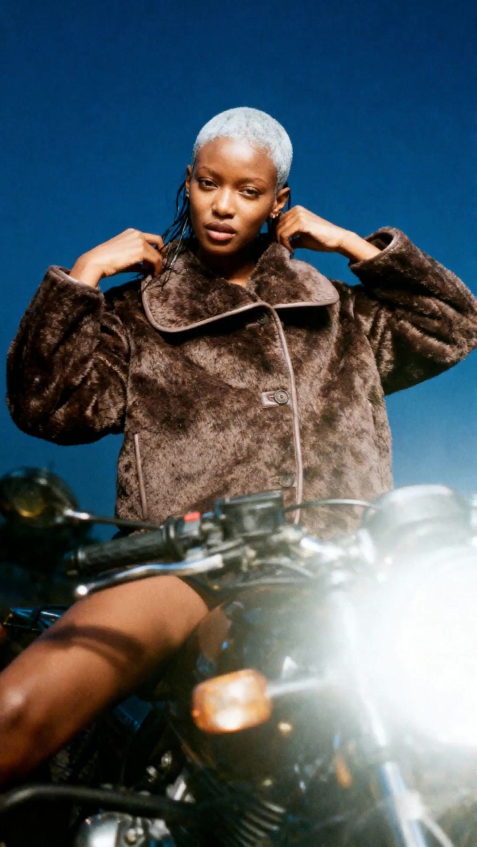 a woman sitting on top of a motorcycle