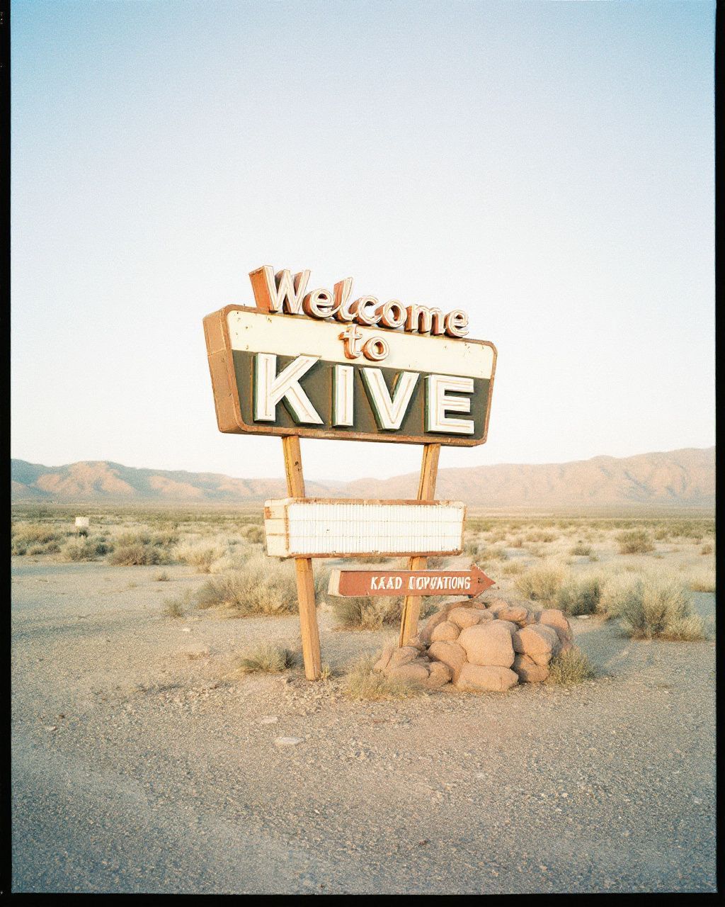 a welcome to kive sign in the desert