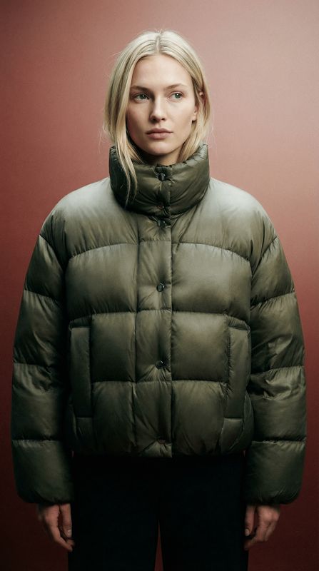 a woman standing in front of a red wall