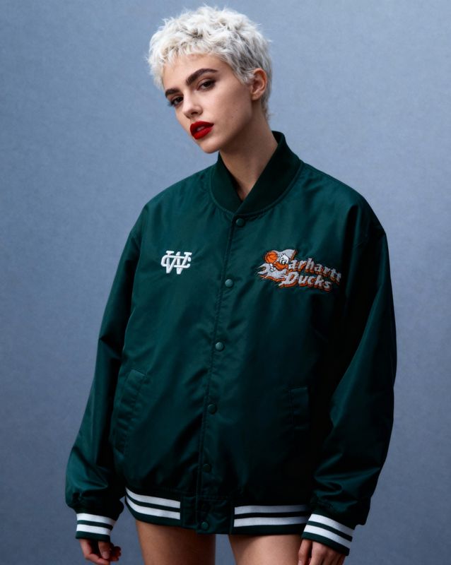 a woman with white hair wearing a green jacket