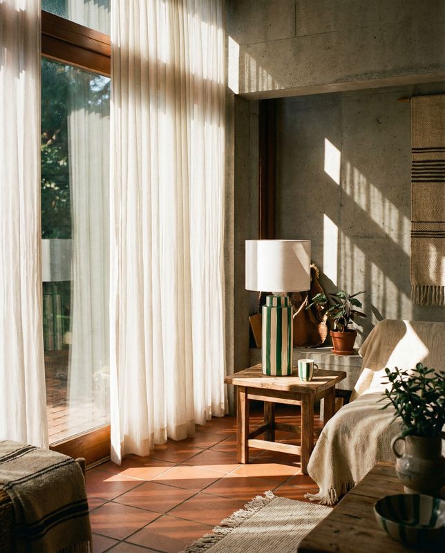 a living room filled with furniture and a large window