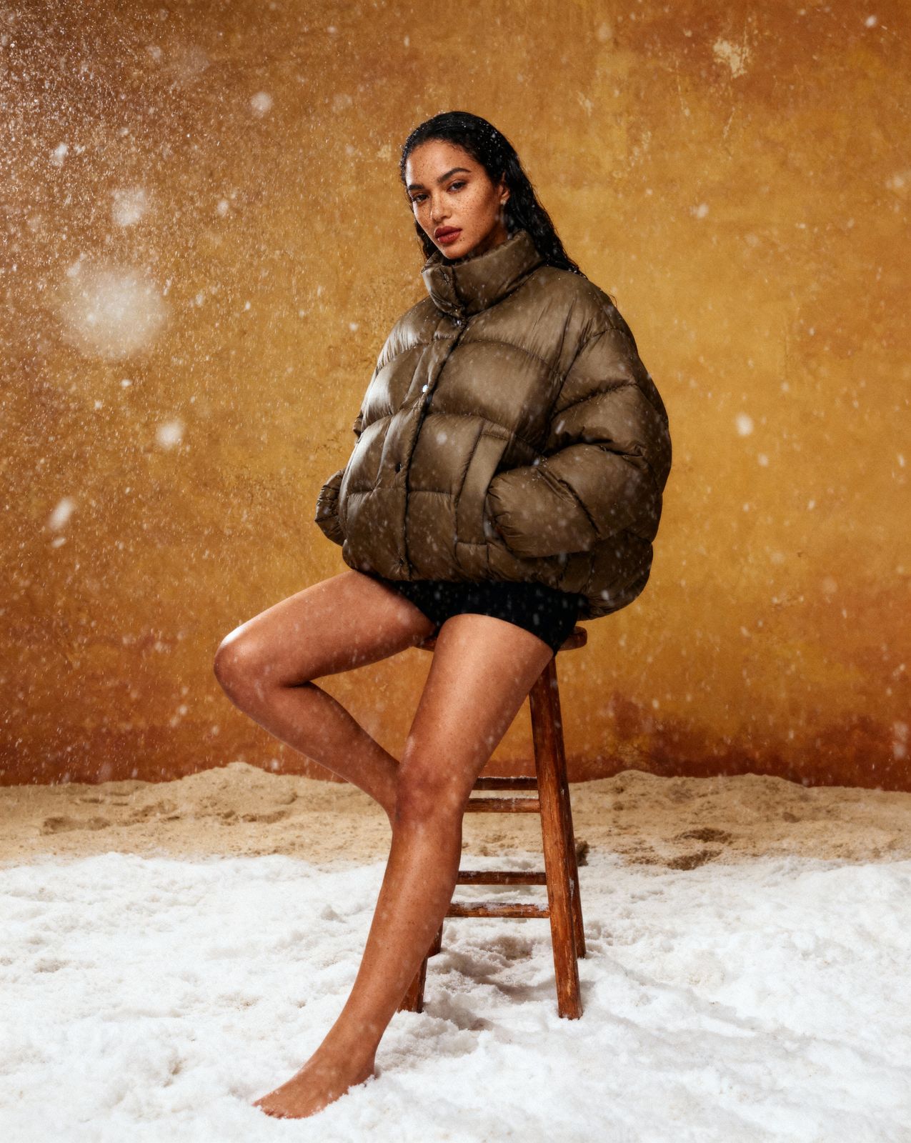 a woman sitting on a chair in the snow