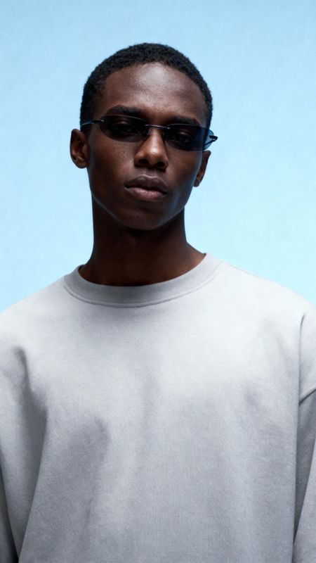 a man wearing sunglasses and a white shirt