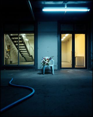 a white chair sitting in front of a fire hydrant