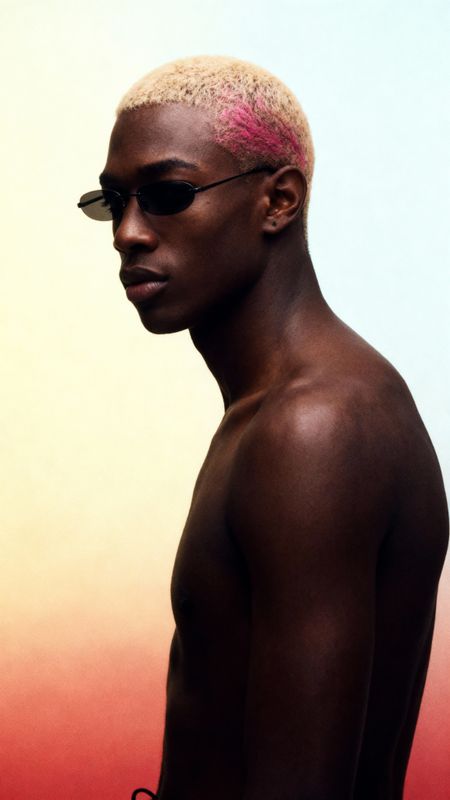 a black man with a pink mohawk and sunglasses