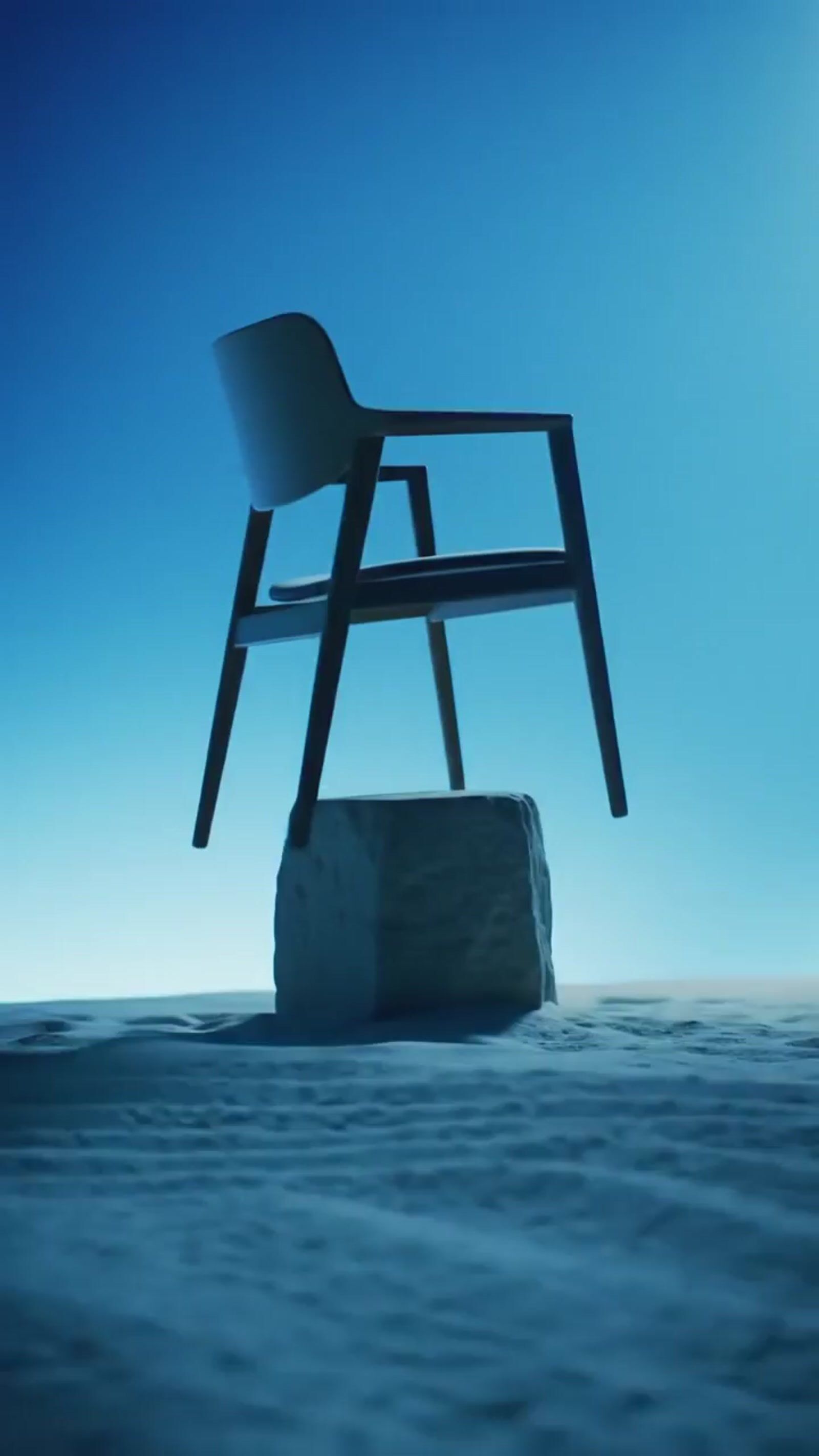 a chair sitting on top of a rock in the ocean