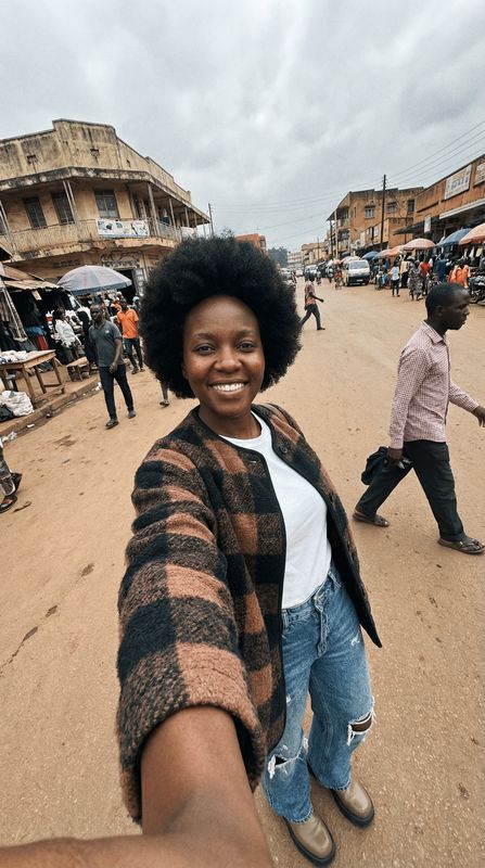 a woman taking a selfie in the middle of a street