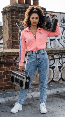a woman holding a boombox and a radio