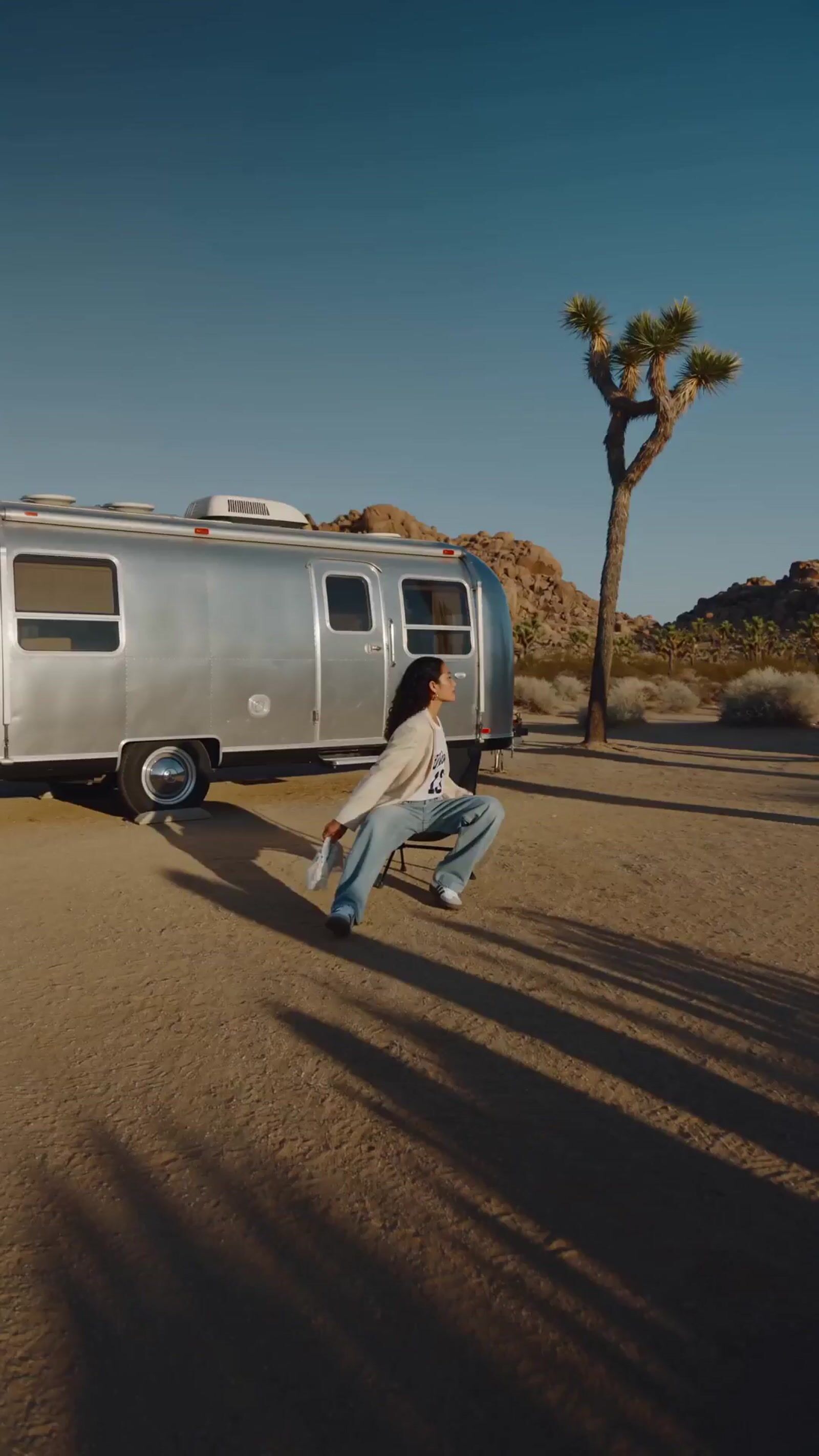a man walking in front of a silver trailer