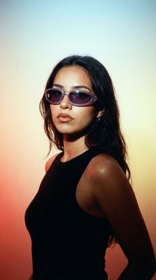 a woman wearing sunglasses posing for a picture