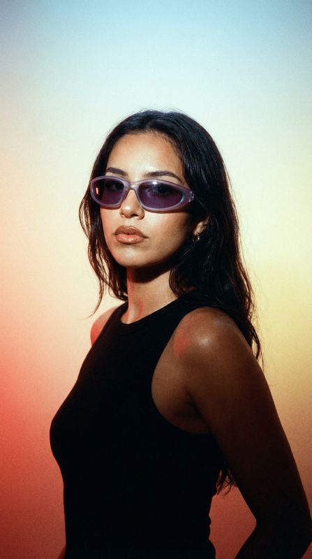 a woman wearing sunglasses posing for a picture