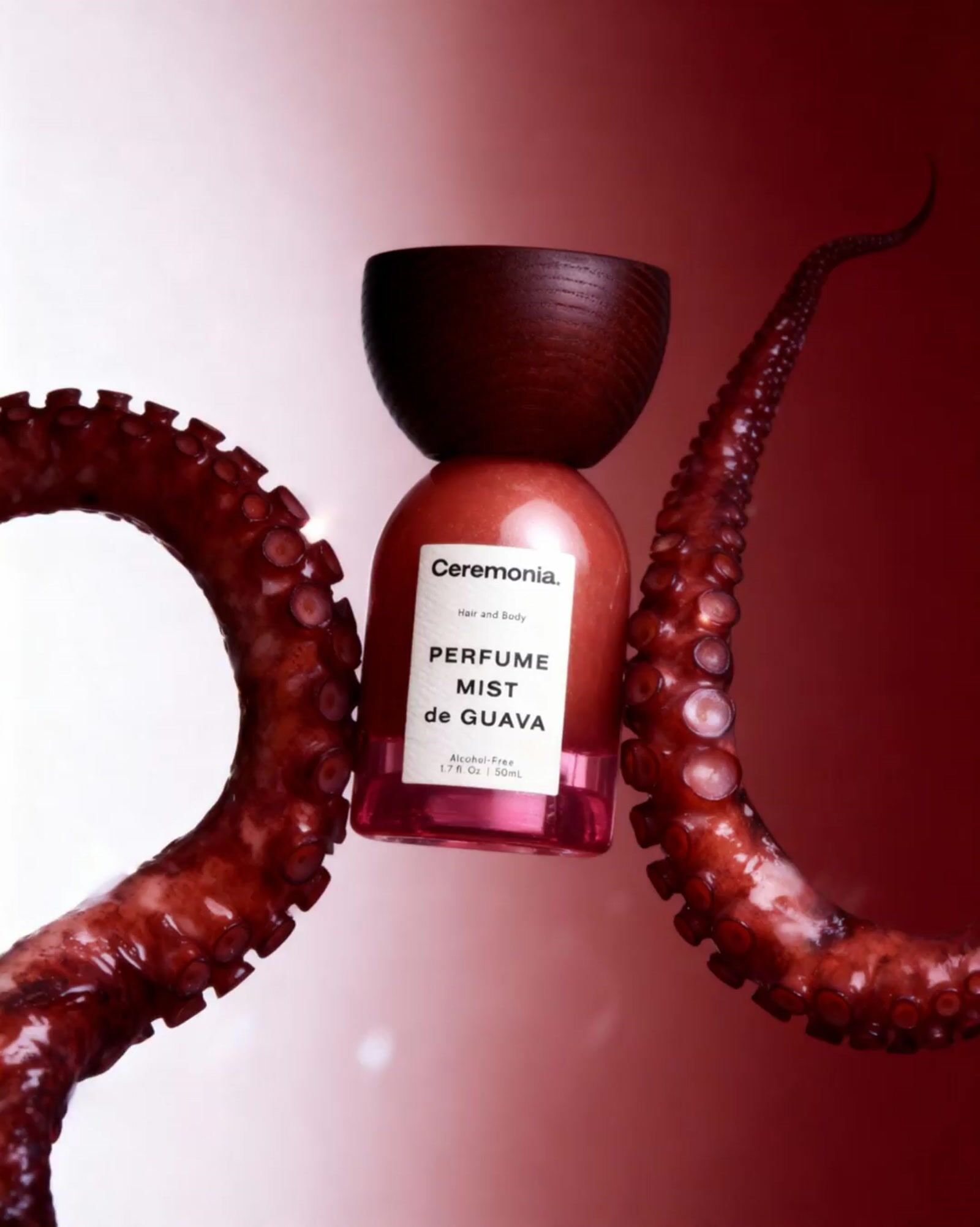 an octopus with a bottle of perfume in it's mouth