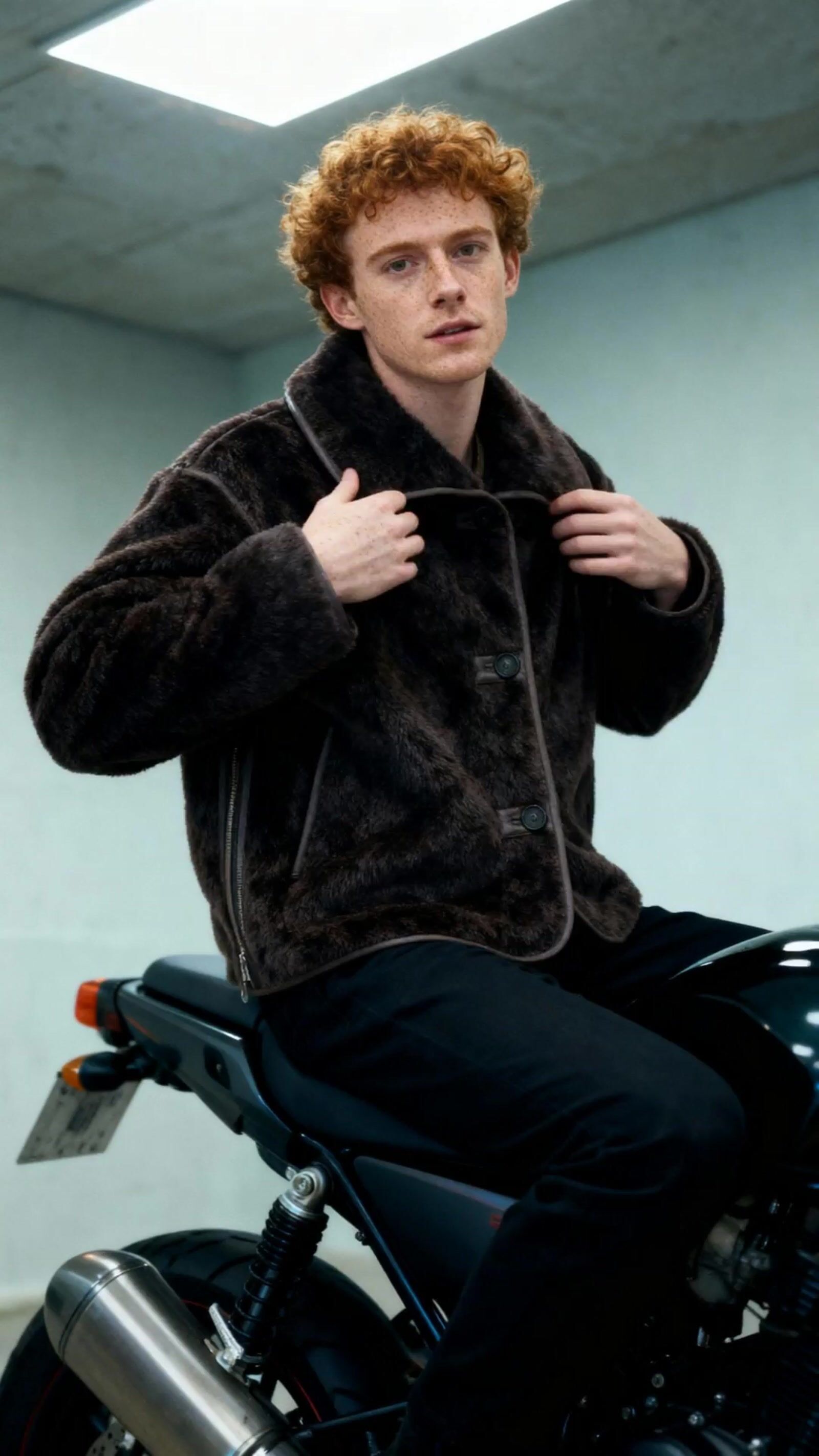 a man sitting on top of a motorcycle