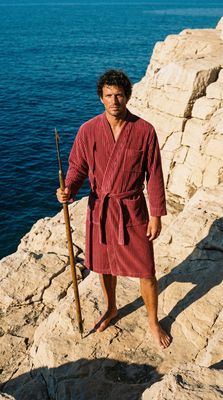 a man in a robe is holding a stick