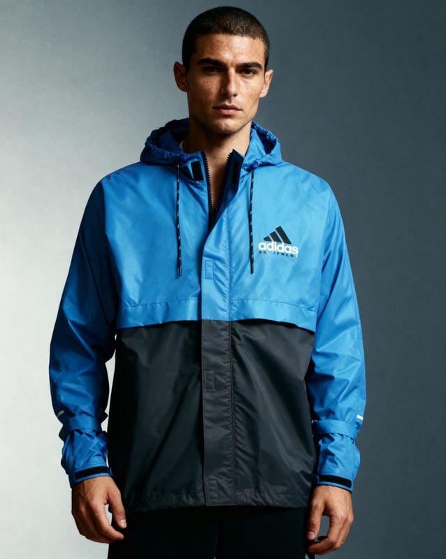 a man wearing a blue and black jacket