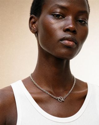 a woman with a necklace on her neck
