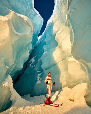 a person on skis standing in an ice cave
