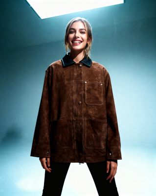 a woman standing in front of a blue background