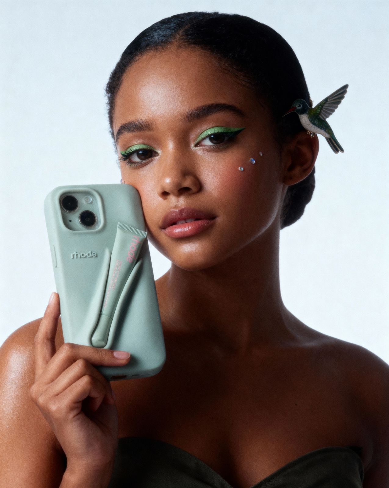 a woman holding a phone in her right hand