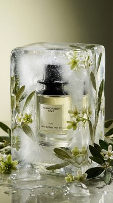 a bottle of perfume sitting on top of a ice block