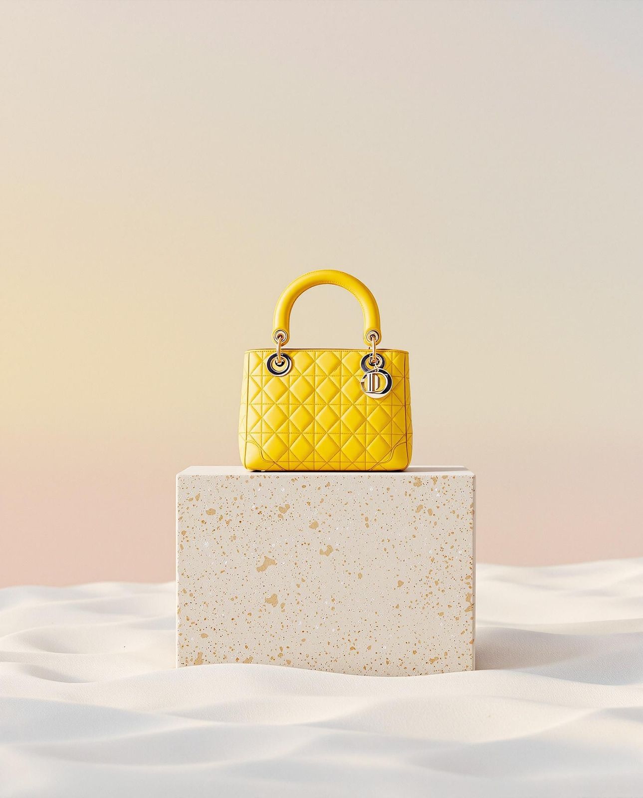 a yellow handbag sitting on top of a white block