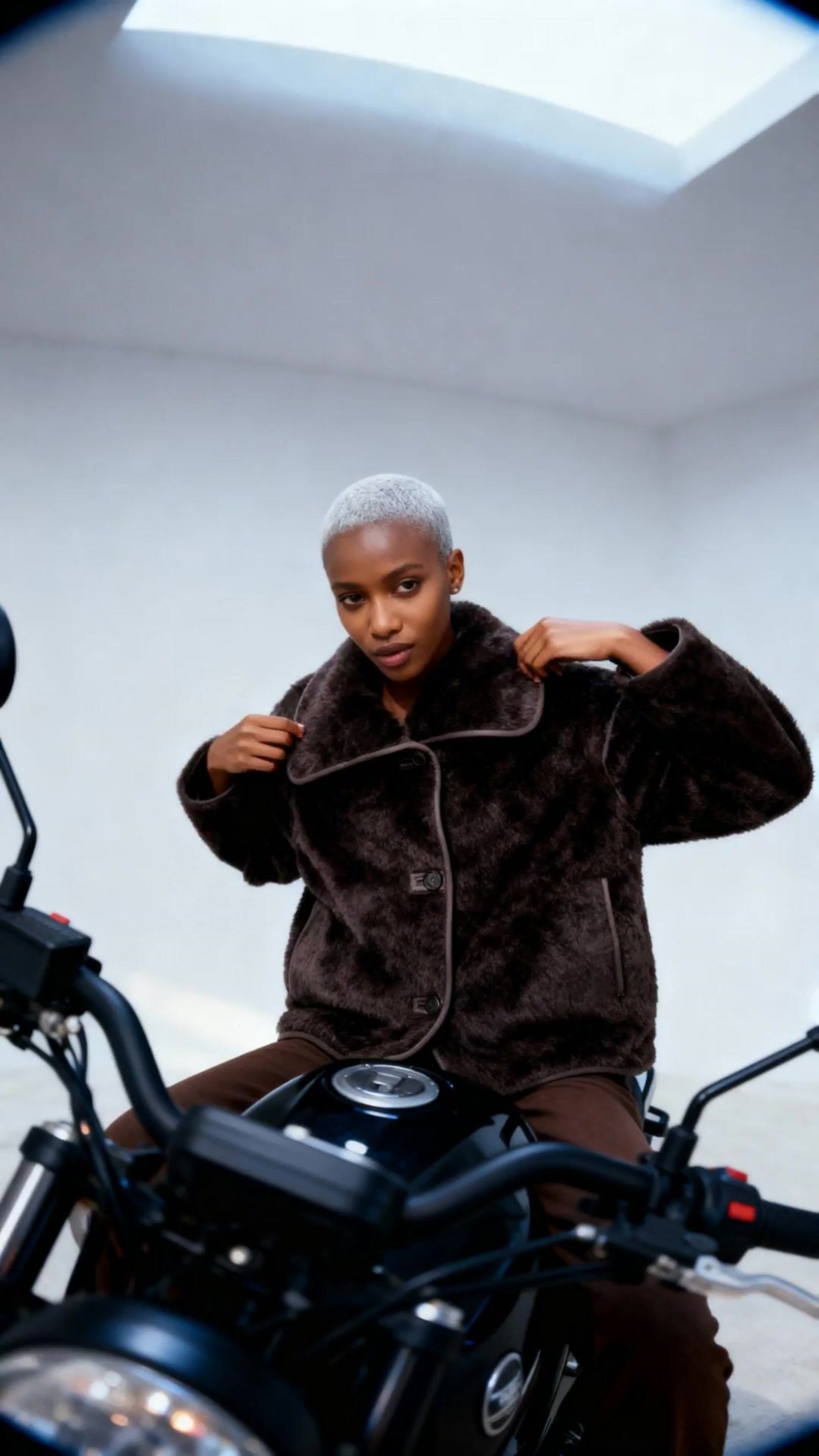 a person sitting on a motorcycle in a room