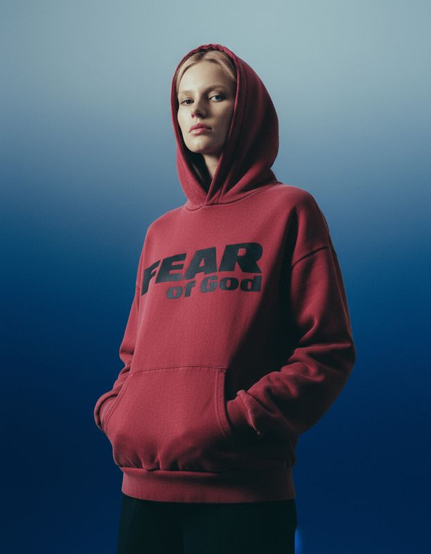 a woman wearing a red hoodie with the word fear on it
