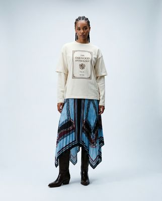 a woman in a white shirt and blue skirt