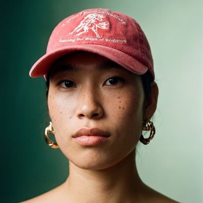 a woman wearing a red hat and hoop earrings