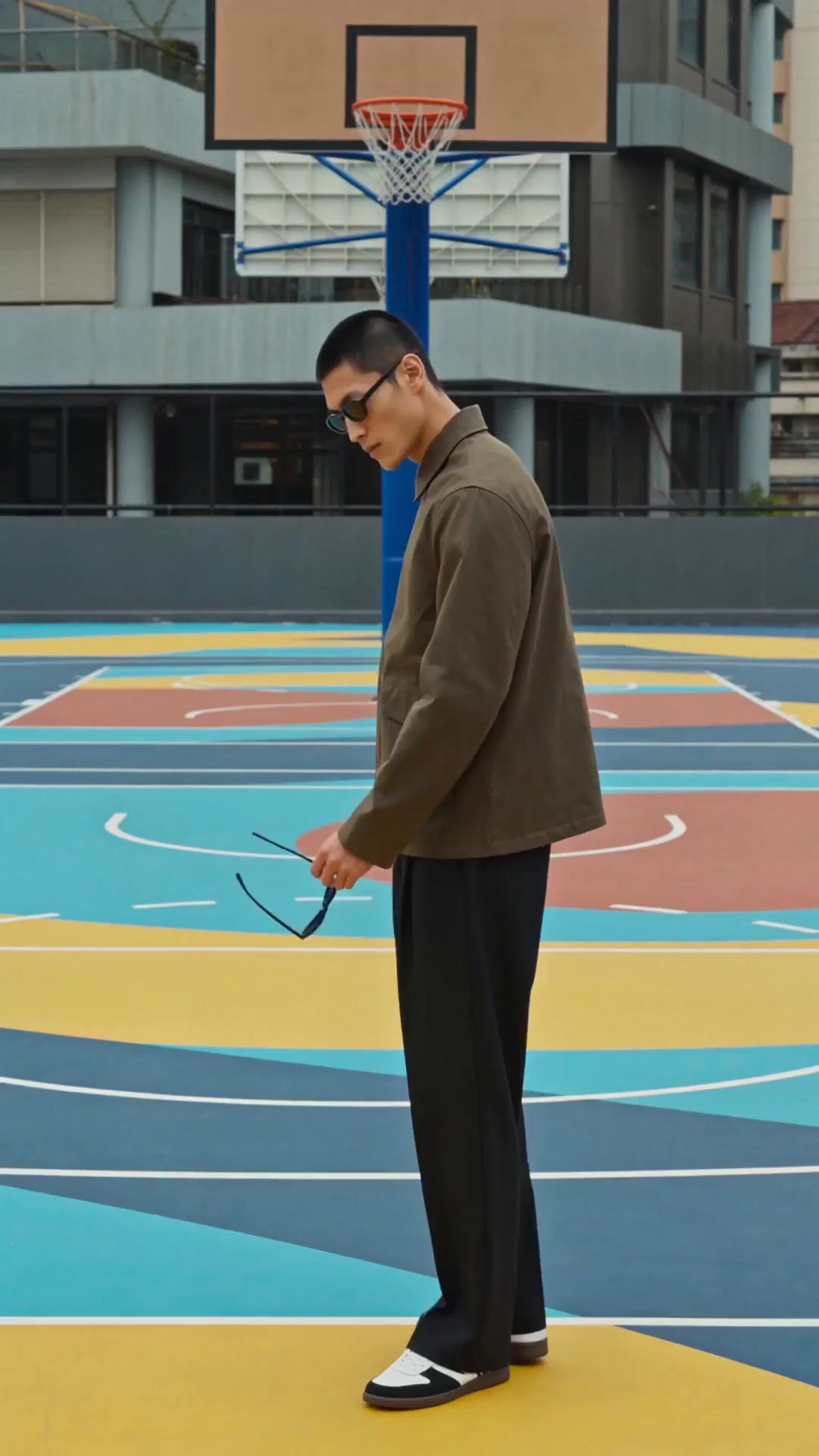 a man standing on top of a basketball court