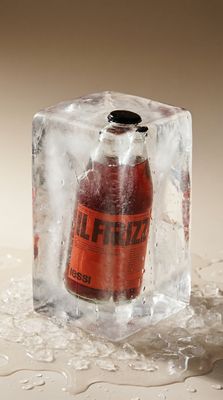 a bottle of fizzy sitting on top of an ice block