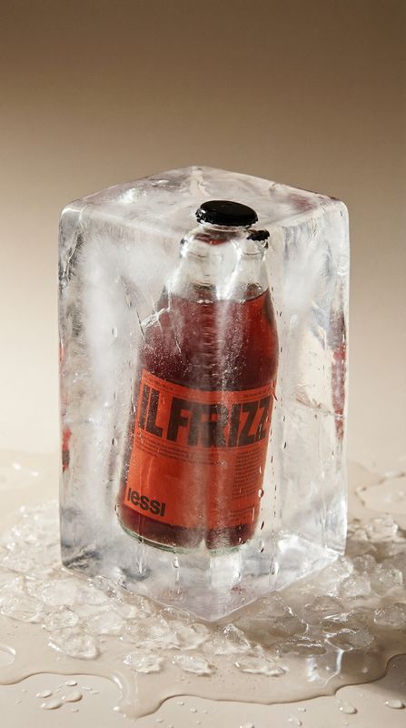 a bottle of fizzy sitting on top of an ice block