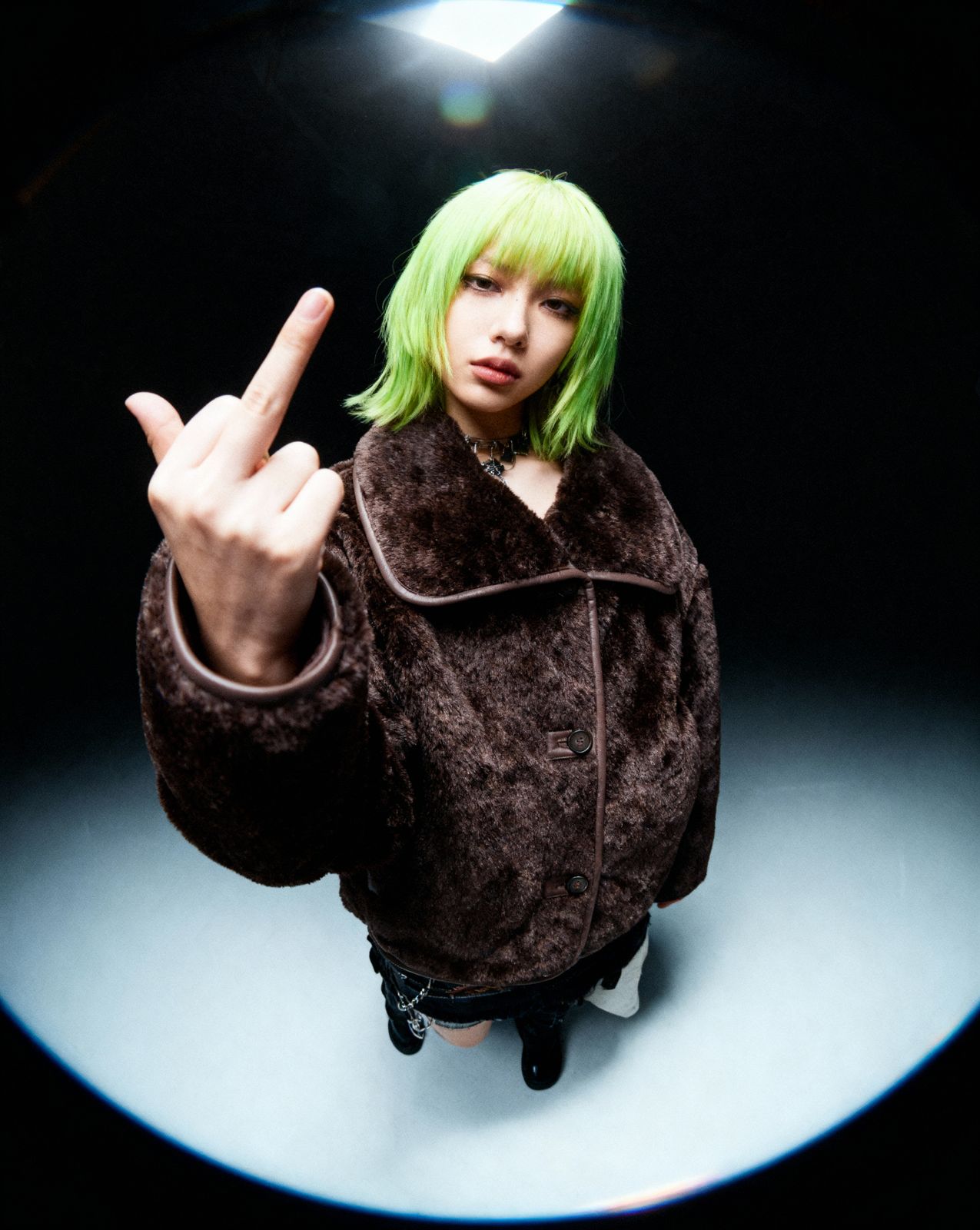 a woman with green hair making a peace sign