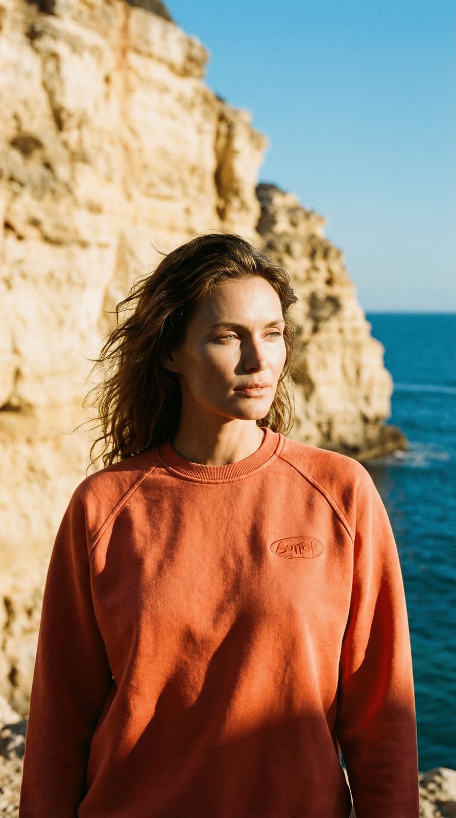 a woman standing in front of a body of water