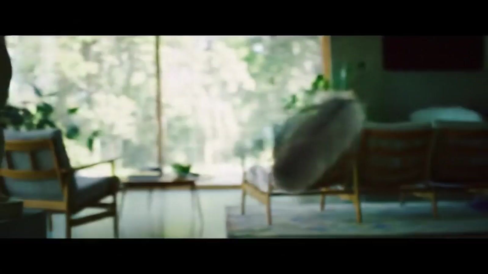 a blurry photo of a living room with a couch and chairs