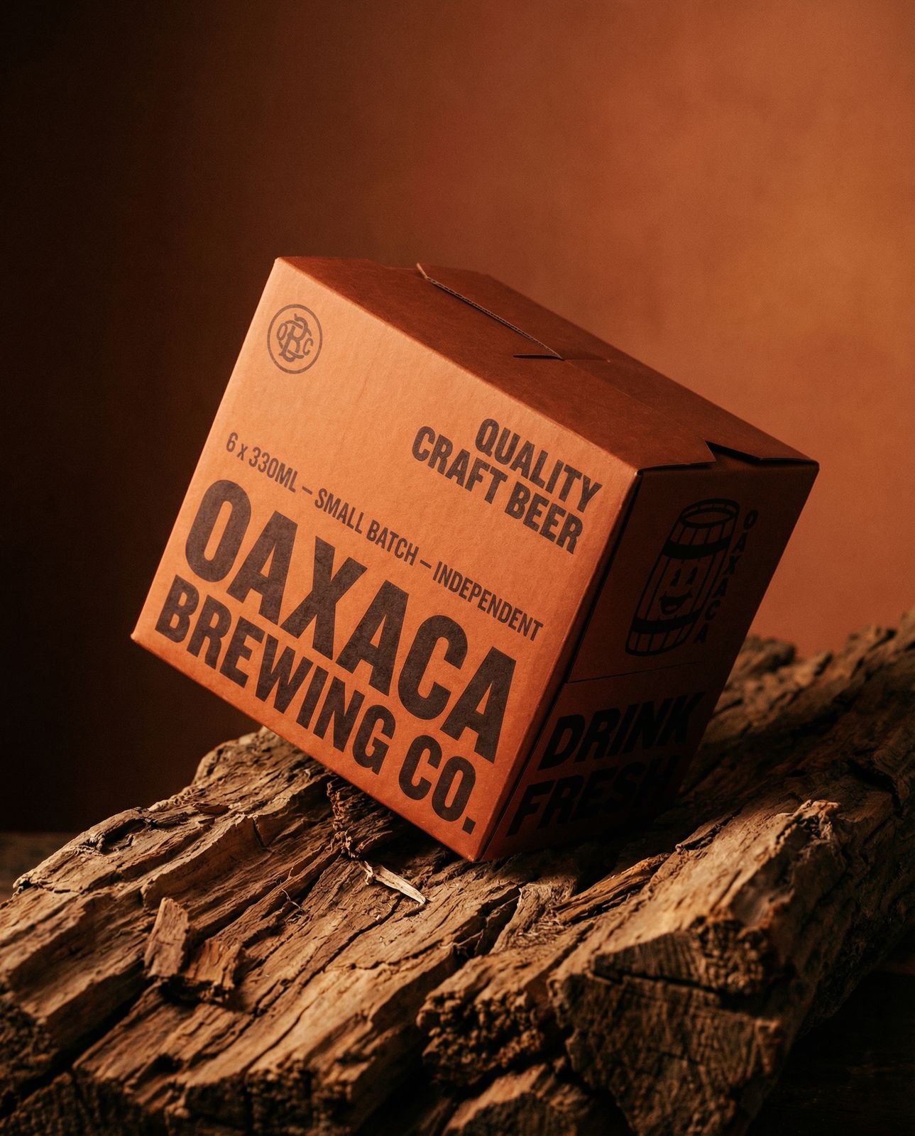 a box of oak beer sitting on top of a piece of wood