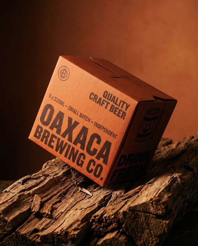 a box of oak beer sitting on top of a piece of wood