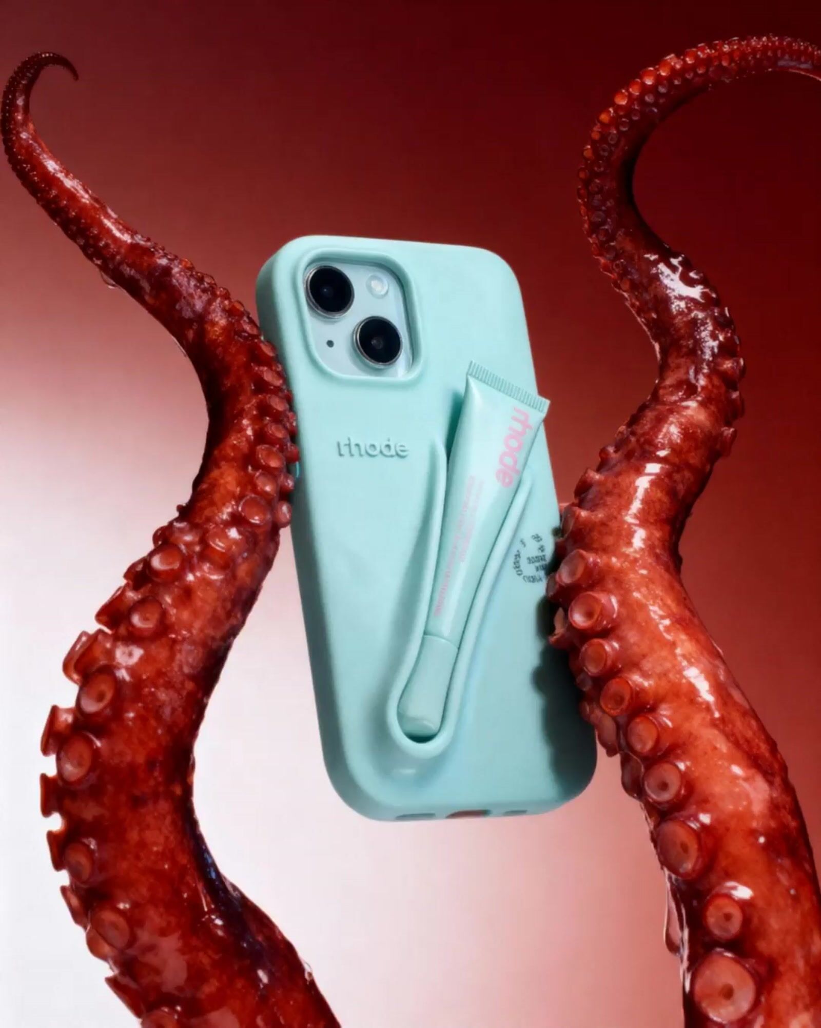 an octopus holding a cell phone in its tentacles