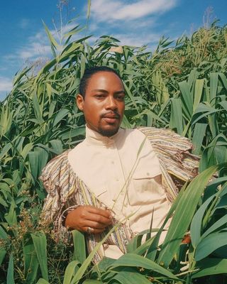 a man standing in a field of corn