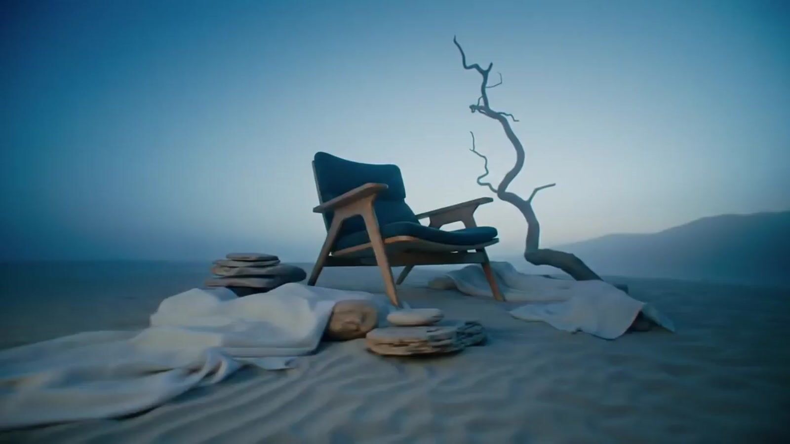 a chair sitting on top of a sandy beach