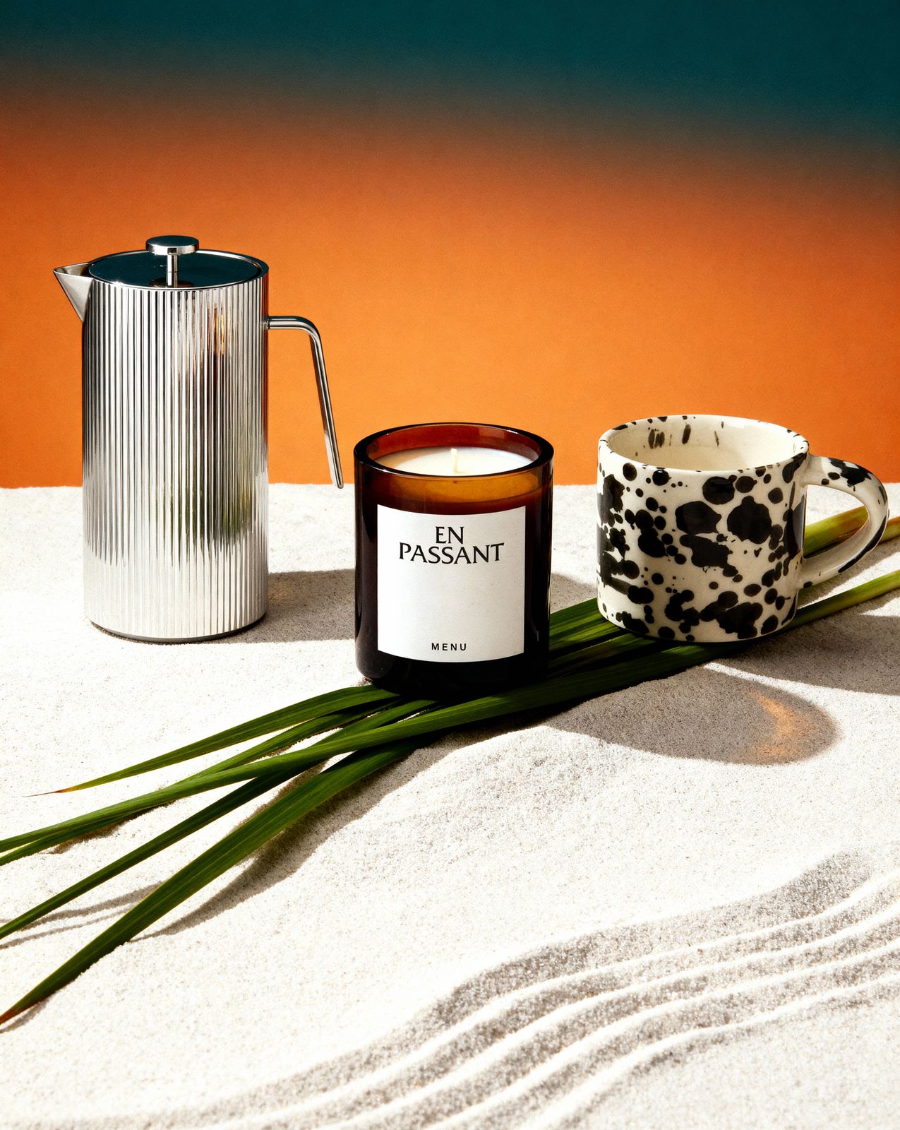 a candle and a cup on a table
