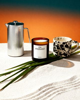 a candle and a cup on a table