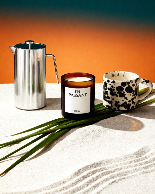 a candle and a cup on a table